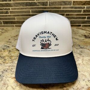 Travis Mathew White and Blue Hat with Wolf Creek Logo